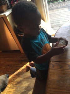 Jimmy opening the diaper rash ointment.